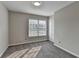 Cozy bedroom with carpet, base molding, a window, and a closet at 4901 Briarleigh Chase Sw, Mableton, GA 30126