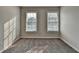 Neutral bedroom with carpet, base molding, and two windows with blinds at 4901 Briarleigh Chase Sw, Mableton, GA 30126