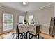 Cozy dining room with warm lighting, wood floors and neutral wall color at 4901 Briarleigh Chase Sw, Mableton, GA 30126