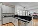 Open kitchen layout with gray cabinets, granite countertops, and view to living room at 4901 Briarleigh Chase Sw, Mableton, GA 30126