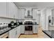 Stylish kitchen featuring gray cabinets, granite countertops, and stainless steel appliances at 4901 Briarleigh Chase Sw, Mableton, GA 30126