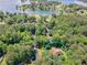 Aerial view of a single Gathering home located near a marina and lakefront community surrounded by lush green trees at 8443 Marina Bay Ct, Jonesboro, GA 30236