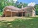 Exterior of the home featuring a large outdoor deck, expansive backyard, and a walkout basement perfect for entertaining at 8443 Marina Bay Ct, Jonesboro, GA 30236
