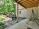 Covered back patio features a stone water feature, swing, and wooded views at 8443 Marina Bay Ct, Jonesboro, GA 30236
