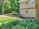 Landscaped backyard with tiered planting beds, waterfall feature, mature plants, and a lovely stream at 8443 Marina Bay Ct, Jonesboro, GA 30236