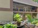 Back of house view highlighting the patio and deck overlooking an outdoor living space and waterfall at 8443 Marina Bay Ct, Jonesboro, GA 30236