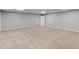 A sprawling basement with plush neutral carpet, light gray walls, and a versatile layout at 8443 Marina Bay Ct, Jonesboro, GA 30236