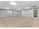 Spacious basement featuring neutral carpeting, recessed lighting, and convenient outdoor access to the home's exterior at 8443 Marina Bay Ct, Jonesboro, GA 30236