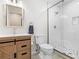 Modern bathroom featuring a wood vanity, stylish fixtures, and a glass-enclosed shower at 8443 Marina Bay Ct, Jonesboro, GA 30236