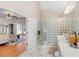 Bathroom with glass block, natural lighting, and an adjacent bedroom with lounge chairs at 8443 Marina Bay Ct, Jonesboro, GA 30236