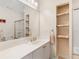 Updated bathroom with vanity, glass shower, and storage shelves at 8443 Marina Bay Ct, Jonesboro, GA 30236