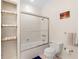 Clean bathroom featuring glass shower, toilet, and ample storage at 8443 Marina Bay Ct, Jonesboro, GA 30236