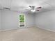 Bedroom with neutral carpet, a ceiling fan, and a view of the backyard at 8443 Marina Bay Ct, Jonesboro, GA 30236