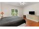 Comfortable bedroom featuring storage cabinets and hardwood floors at 8443 Marina Bay Ct, Jonesboro, GA 30236