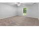 Bedroom with neutral carpet, a ceiling fan, and a view of the backyard at 8443 Marina Bay Ct, Jonesboro, GA 30236