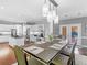 Open dining space featuring modern pendant lighting, access to the kitchen, and deck at 8443 Marina Bay Ct, Jonesboro, GA 30236