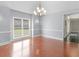 Bright dining room with hardwood floors and natural light from large window at 8443 Marina Bay Ct, Jonesboro, GA 30236