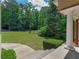 Lush front yard and manicured landscaping with a columned front porch at 8443 Marina Bay Ct, Jonesboro, GA 30236