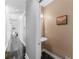 Bright hallway leading to a half bathroom, featuring tiled floors and an ornate border at 8443 Marina Bay Ct, Jonesboro, GA 30236