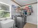 Well-equipped laundry room with modern washer and dryer, sink, and ample storage shelving at 8443 Marina Bay Ct, Jonesboro, GA 30236
