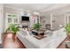 Spacious living room featuring hardwood floors, a stone fireplace with mounted TV, modern chandelier, and natural light at 8443 Marina Bay Ct, Jonesboro, GA 30236