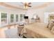 Sunlit main bedroom suite with tray ceiling, view of the outdoor deck and wooded area at 8443 Marina Bay Ct, Jonesboro, GA 30236