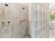 Luxurious walk-in shower featuring stone accents and dual showerheads at 8443 Marina Bay Ct, Jonesboro, GA 30236