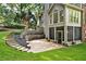 A screened-in porch and stone patio are showcased along with a terraced garden and staircase, enhancing outdoor living at 870 River Cliff Ct, Suwanee, GA 30024