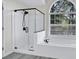 Modern bathroom featuring a glass-enclosed shower and separate soaking tub at 870 River Cliff Ct, Suwanee, GA 30024