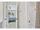 A bright bathroom and view into an adjacent bedroom with a patterned comforter at 870 River Cliff Ct, Suwanee, GA 30024