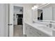 Bright Primary bathroom with double vanity, sleek hardware, and a view into an adjacent bedroom at 870 River Cliff Ct, Suwanee, GA 30024