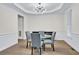 Formal dining room with wood flooring, designer lighting, and ample space for entertaining guests at 870 River Cliff Ct, Suwanee, GA 30024
