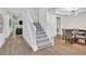 Bright foyer featuring hardwood floors, a staircase, and views into the living room and dining area at 870 River Cliff Ct, Suwanee, GA 30024