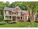 Beautiful brick two-story home with manicured lawn, black shutters, and a welcoming front porch, exuding curb appeal at 870 River Cliff Ct, Suwanee, GA 30024