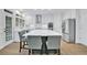 Modern kitchen with white cabinets, stainless appliances, and a large central island at 870 River Cliff Ct, Suwanee, GA 30024