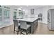 Modern kitchen featuring a large island, stainless steel appliances, and sleek white cabinetry at 870 River Cliff Ct, Suwanee, GA 30024