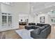 Bright open-concept living room with hardwood flooring, a fireplace, and views into the kitchen at 870 River Cliff Ct, Suwanee, GA 30024