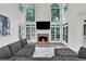 Two-story living room with large windows, brick fireplace and lots of natural light at 870 River Cliff Ct, Suwanee, GA 30024