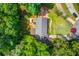 Aerial view of the home with a deck, lush greenery, and a well-manicured lawn at 905 Foxfire Dr, Lawrenceville, GA 30044