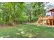 Spacious backyard featuring a wooden deck and patio area, ideal for outdoor entertainment at 905 Foxfire Dr, Lawrenceville, GA 30044