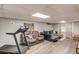 Finished basement features wood flooring, a treadmill, and two comfortable couches at 905 Foxfire Dr, Lawrenceville, GA 30044