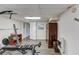 Finished basement features wood floors and a workout bench with an armoire in the background at 905 Foxfire Dr, Lawrenceville, GA 30044