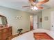 This light green bedroom offers wood floors, natural light, and a tranquil decor at 905 Foxfire Dr, Lawrenceville, GA 30044
