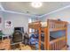 Well-lit bedroom with hardwood floors, custom wall decor, and a wooden bunk bed at 905 Foxfire Dr, Lawrenceville, GA 30044