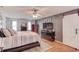 This primary bedroom offers ample natural light, hardwood flooring, and modern ceiling fan at 905 Foxfire Dr, Lawrenceville, GA 30044