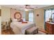 Bright bedroom featuring warm color accents, hardwood flooring, and large sunny windows at 905 Foxfire Dr, Lawrenceville, GA 30044