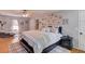 Spacious main bedroom with ceiling fan, hardwood floors, a large bed, and neutral decor at 905 Foxfire Dr, Lawrenceville, GA 30044