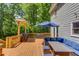 Wooden deck features covered area, outdoor furniture, a grill and great wooded views at 905 Foxfire Dr, Lawrenceville, GA 30044