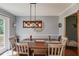 Cozy dining area with a wooden table and stylish lighting fixture at 905 Foxfire Dr, Lawrenceville, GA 30044