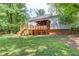Back exterior of home with a large wooden deck, screen porch, and spacious backyard at 905 Foxfire Dr, Lawrenceville, GA 30044
